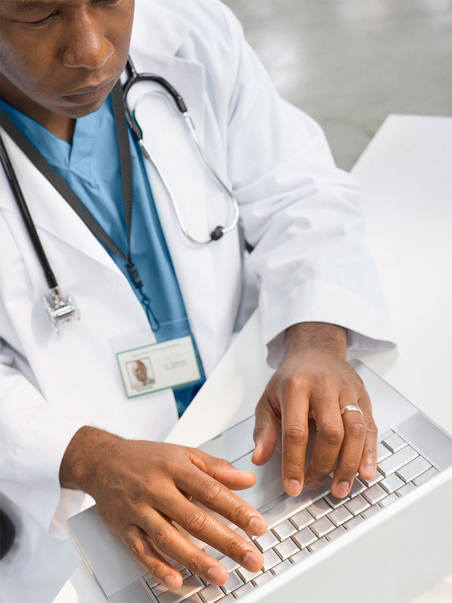 Doctor using laptop, targeted in EHR by HCP Marketing Solutions  