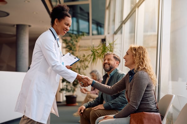 Healthcare provider shaking hands with patient