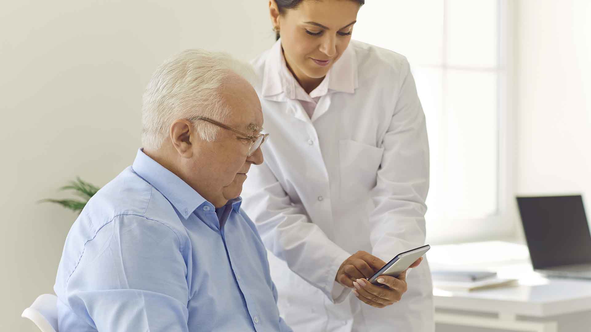 female doctor showing support text messages to elder patient