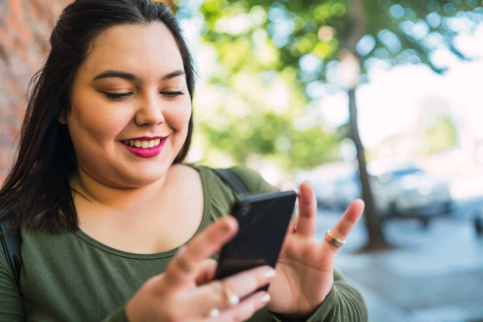female reading a text message smiling